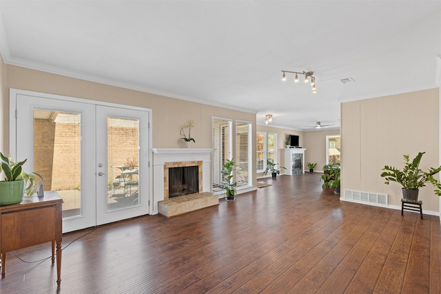 5008 Santa Elena Ct, Granbury, TX 76049 - living area featuring ceiling fan, wood finished floors, visible vents, and a fireplace