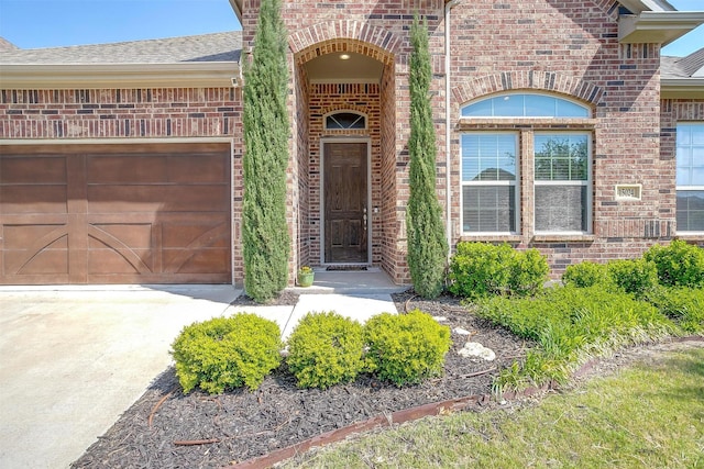 15024 Teasley Ave, Aledo, TX 76008 - doorway to property featuring brick siding, driveway, roof with shingles, and a garage