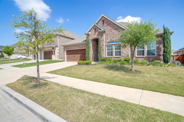 15024 Teasley Ave, Aledo, TX 76008 - view of front facade featuring a garage, a front yard, driveway, and brick siding