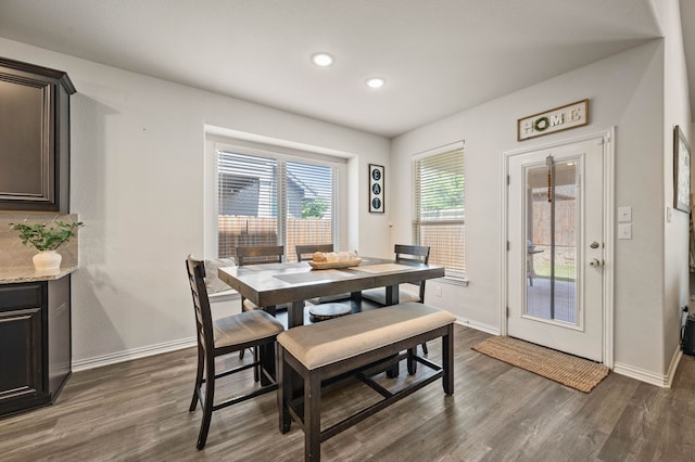 dining space featuring baseboards, recessed lighting, and dark wood finished floors
