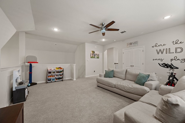 carpeted living area with recessed lighting, arched walkways, visible vents, and ceiling fan
