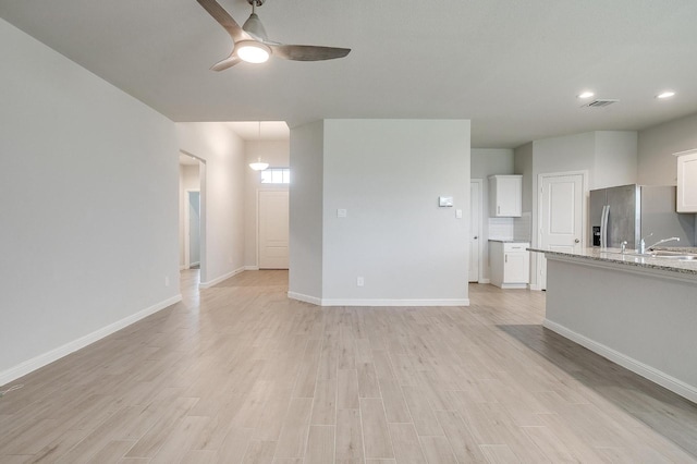 9625 Catclaw Ter, Fort Worth, TX 76036 - unfurnished living room featuring light wood-style flooring, a ceiling fan, baseboards, recessed lighting, and visible vents