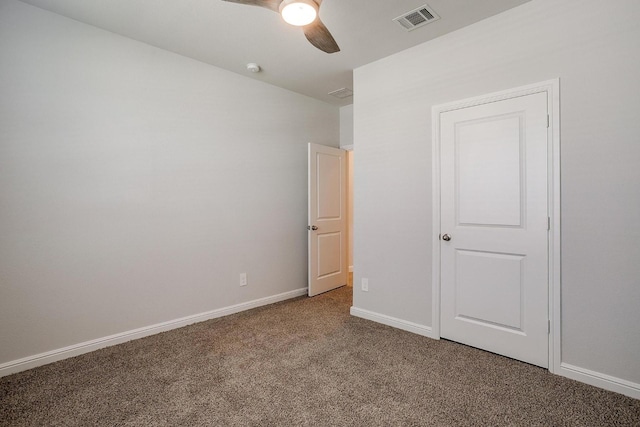 unfurnished bedroom featuring carpet floors, baseboards, a ceiling fan, and visible vents