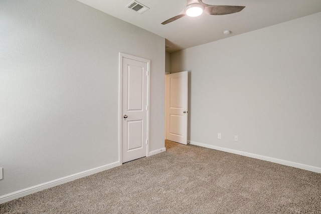 spare room featuring baseboards, ceiling fan, carpet, and visible vents