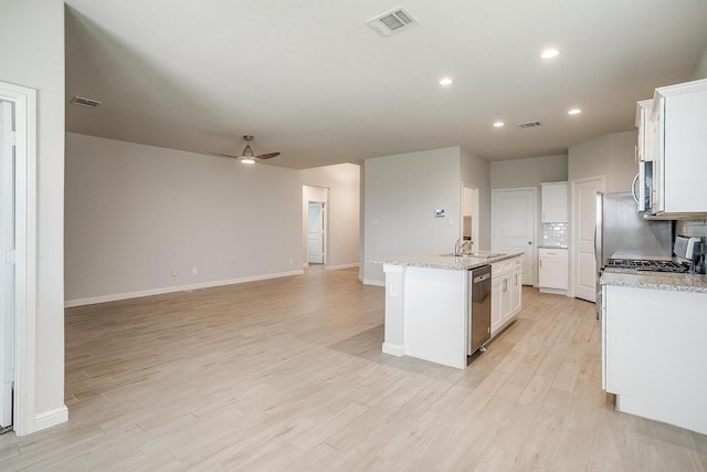 kitchen with visible vents, light wood-type flooring, appliances with stainless steel finishes, and ceiling fan