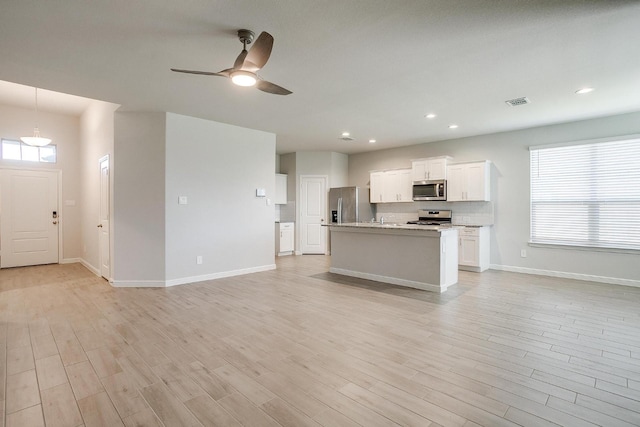 9625 Catclaw Ter, Fort Worth, TX 76036 - kitchen with appliances with stainless steel finishes, open floor plan, a ceiling fan, and recessed lighting