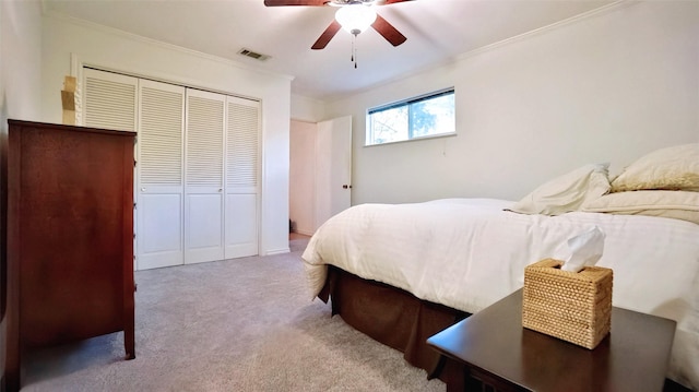 bedroom featuring carpet flooring, visible vents, a closet, ceiling fan, and ornamental molding