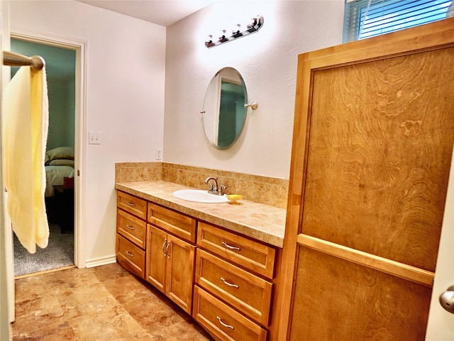 ensuite bathroom featuring vanity and connected bathroom