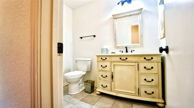 bathroom featuring toilet, vanity, and tile patterned floors