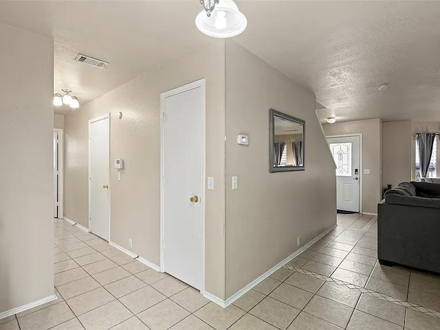 130 Walnut Dr, Seagoville, TX 75159 - hallway featuring baseboards and light tile patterned floors
