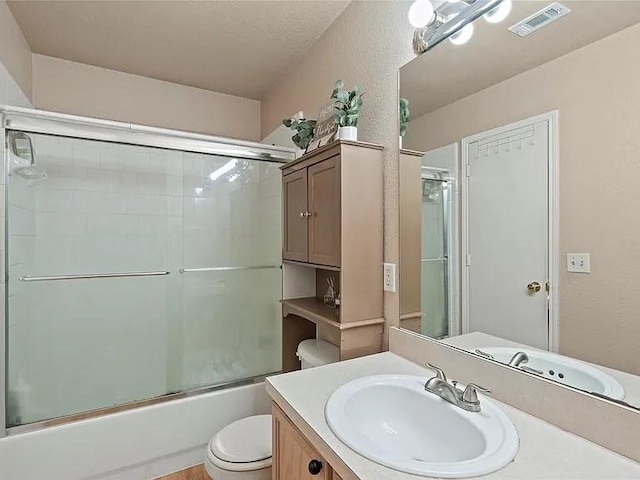 130 Walnut Dr, Seagoville, TX 75159 - full bathroom with vanity, toilet, visible vents, and enclosed tub / shower combo