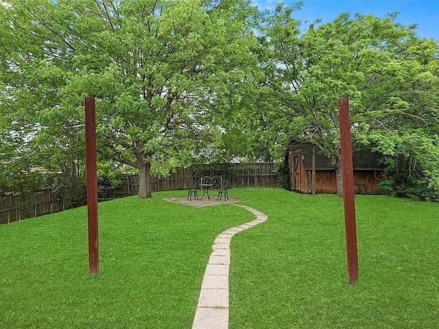 130 Walnut Dr, Seagoville, TX 75159 - view of yard with an outbuilding, a fenced backyard, and a storage unit