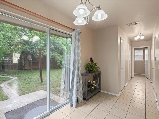 130 Walnut Dr, Seagoville, TX 75159 - doorway to outside with an inviting chandelier, light tile patterned floors, visible vents, and baseboards