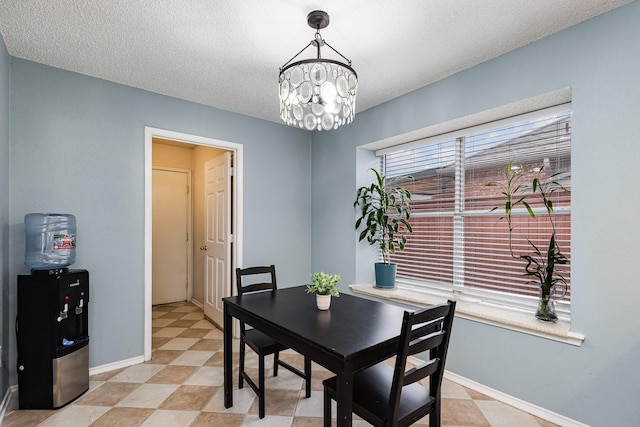 900 Valley View Dr, Lewisville, TX 75067 - dining area with an inviting chandelier, a textured ceiling, and baseboards