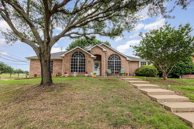 900 Valley View Dr, Lewisville, TX 75067 - view of front facade with roof with shingles, brick siding, and a front yard