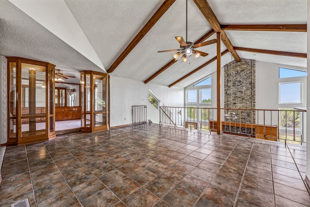 unfurnished living room with high vaulted ceiling, a textured ceiling, a wealth of natural light, and ceiling fan