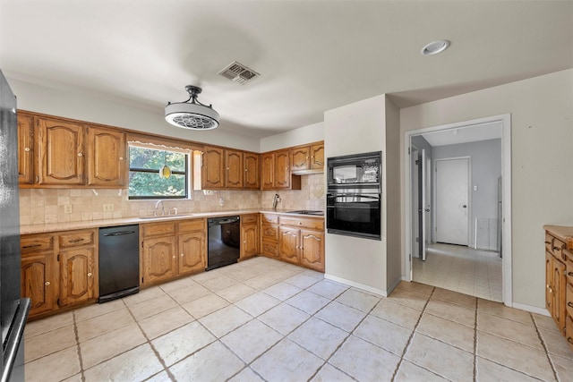 kitchen featuring light tile patterned flooring, backsplash, visible vents, and black appliances