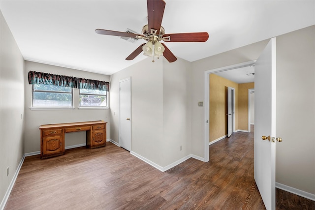 interior space featuring wood finished floors, baseboards, and ceiling fan