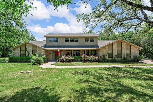 traditional-style home featuring brick siding and a front yard