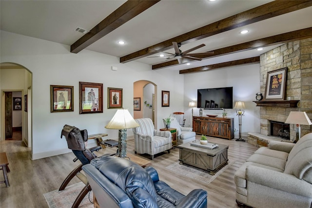 1601 Harbor Lakes Dr, Granbury, TX 76048 - living room featuring arched walkways, ceiling fan, light wood-type flooring, baseboards, and beam ceiling