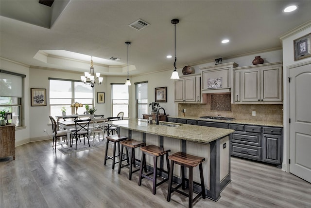 1601 Harbor Lakes Dr, Granbury, TX 76048 - kitchen with a sink, ornamental molding, stainless steel gas stovetop, a kitchen bar, and backsplash