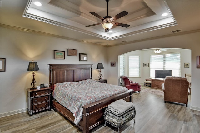1601 Harbor Lakes Dr, Granbury, TX 76048 - bedroom featuring a raised ceiling, arched walkways, light wood-style floors, ornamental molding, and baseboards