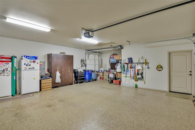 1601 Harbor Lakes Dr, Granbury, TX 76048 - garage featuring freestanding refrigerator and a garage door opener