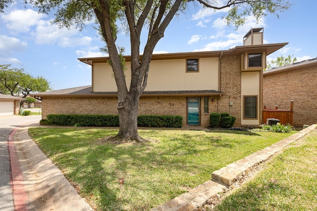 24 Cedar Ln, Bedford, TX 76021 - view of front of house with a chimney, a front yard, and brick siding
