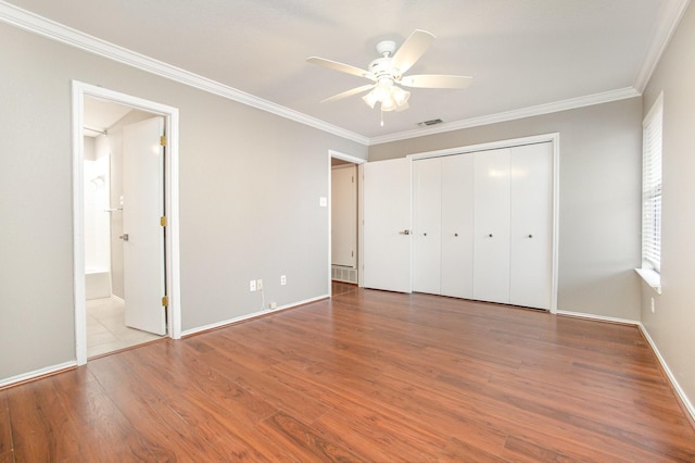 24 Cedar Ln, Bedford, TX 76021 - unfurnished bedroom featuring wood finished floors, ornamental molding, a closet, baseboards, and ceiling fan