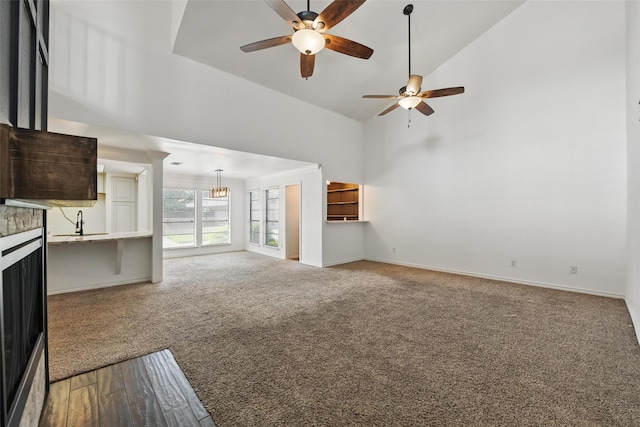 8104 Lea Shore St, Fort Worth, TX 76179 - unfurnished living room with a sink, baseboards, high vaulted ceiling, carpet flooring, and ceiling fan with notable chandelier