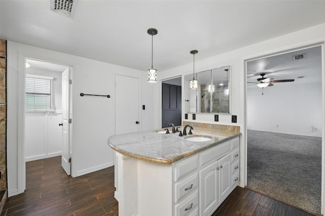 8104 Lea Shore St, Fort Worth, TX 76179 - kitchen with a peninsula, ceiling fan, light stone counters, and a sink