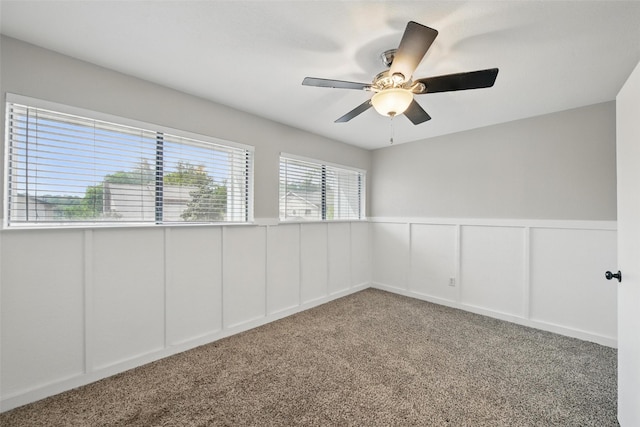 8104 Lea Shore St, Fort Worth, TX 76179 - empty room featuring a ceiling fan, carpet floors, a wainscoted wall, and a decorative wall