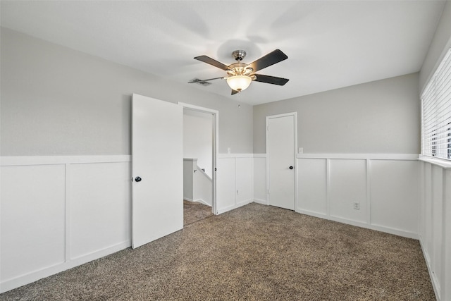 8104 Lea Shore St, Fort Worth, TX 76179 - unfurnished bedroom with ceiling fan, wainscoting, a decorative wall, carpet, and visible vents