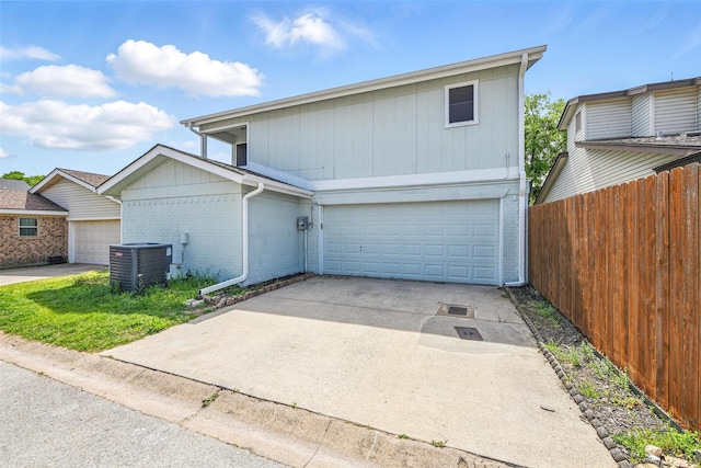 8104 Lea Shore St, Fort Worth, TX 76179 - view of front of property featuring a garage, brick siding, fence, cooling unit, and concrete driveway