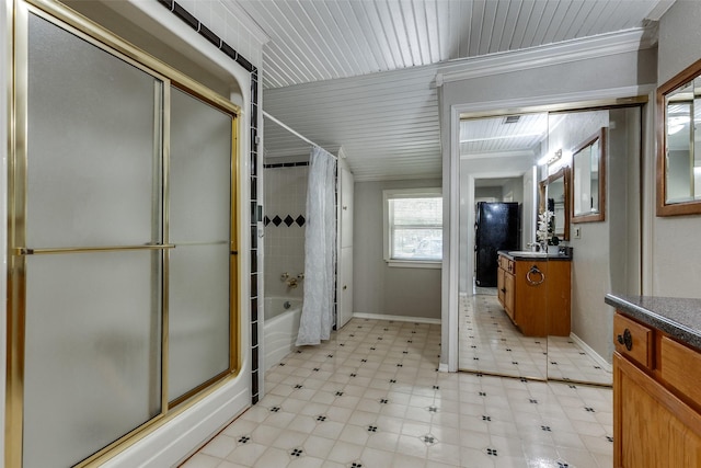 bathroom with tile patterned floors, shower / bath combo, vanity, and baseboards
