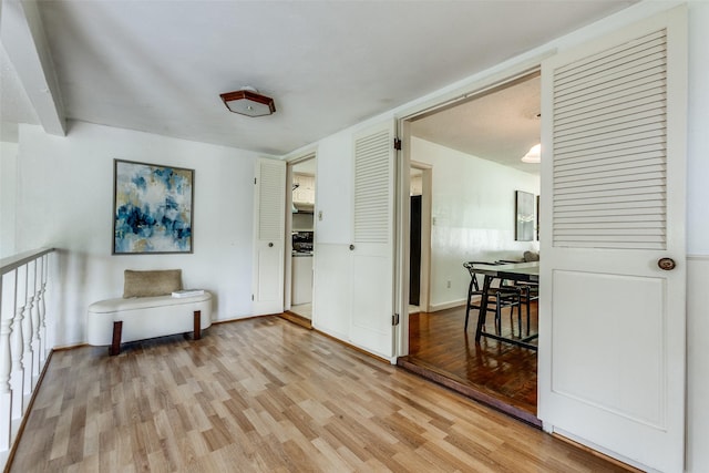 spare room with baseboards and light wood finished floors