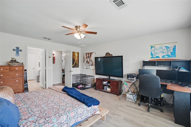 bedroom with ceiling fan, wood finished floors, and visible vents