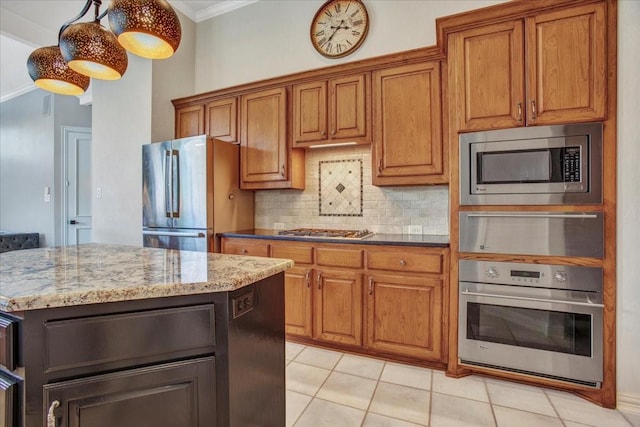 kitchen featuring stainless steel appliances, backsplash, brown cabinets, and crown molding