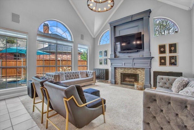 living area with high vaulted ceiling, a notable chandelier, visible vents, and a fireplace