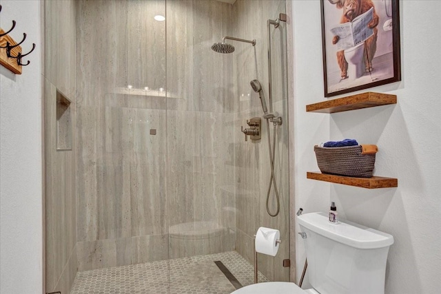 full bath featuring toilet and tiled shower