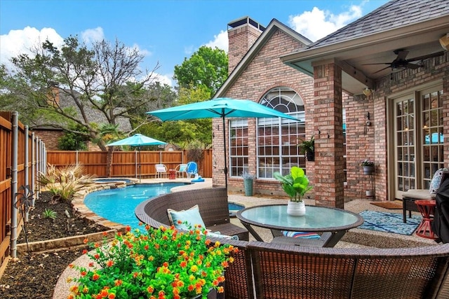 view of pool with a fenced backyard, a patio, ceiling fan, and an in ground hot tub