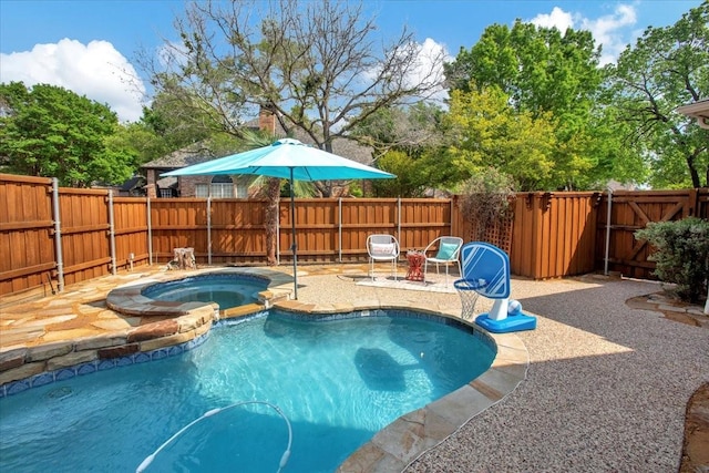 view of pool with a fenced backyard, a patio area, a fenced in pool, and an in ground hot tub