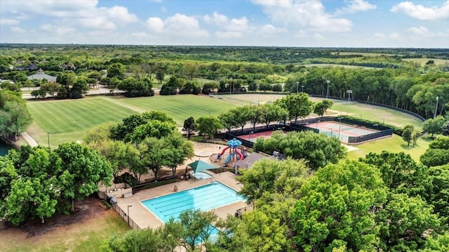 drone / aerial view with a wooded view