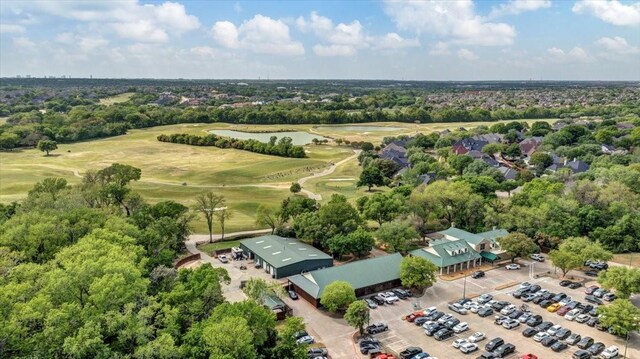 birds eye view of property featuring view of golf course and a water view