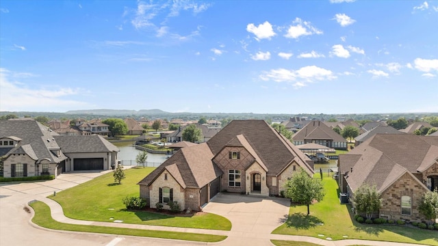 birds eye view of property featuring a residential view and a water view