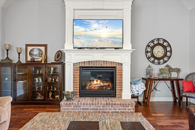 interior space featuring a fireplace and dark wood-style flooring