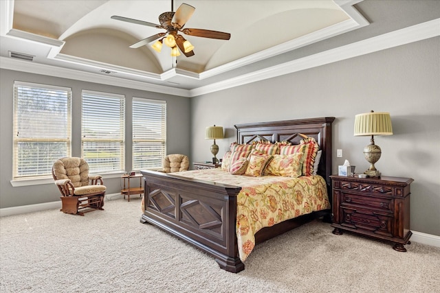 bedroom with ornamental molding, carpet flooring, a tray ceiling, and visible vents