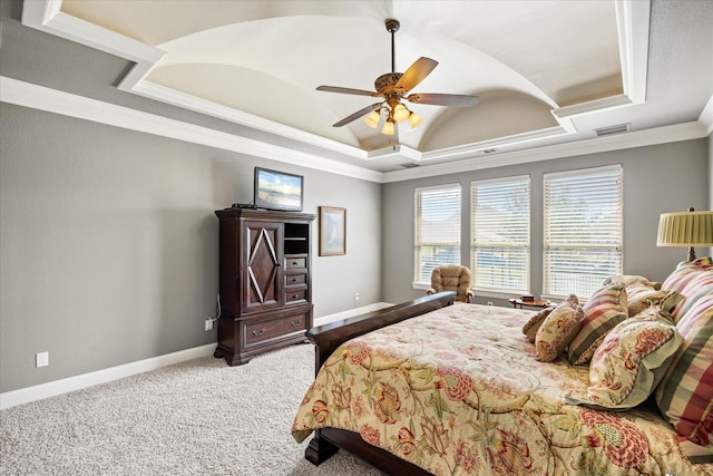 bedroom featuring a tray ceiling, visible vents, crown molding, carpet flooring, and ceiling fan