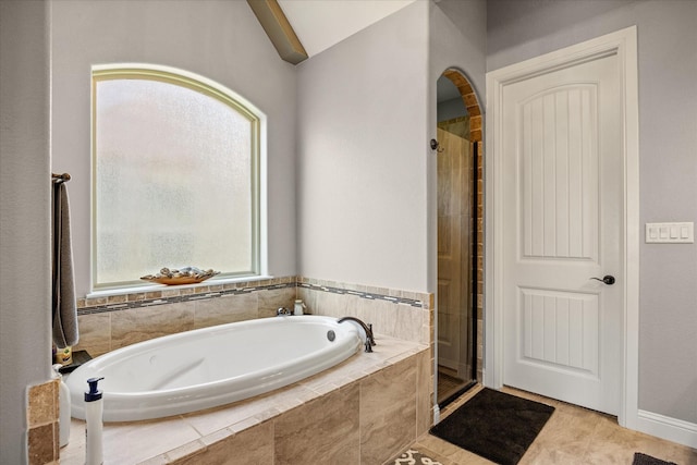 full bath with a garden tub and a stall shower
