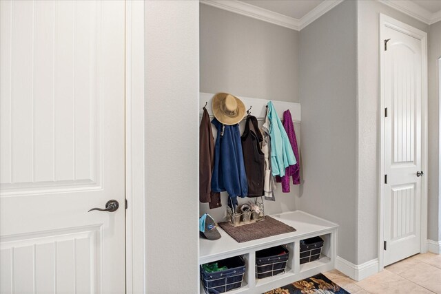 mudroom with tile patterned floors, baseboards, and ornamental molding